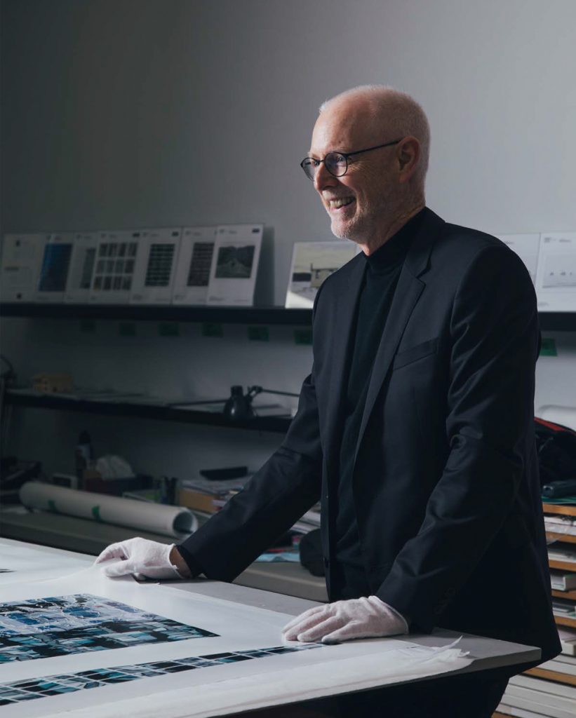Richard Johnson poses in front of light table as he reviews his film photography.